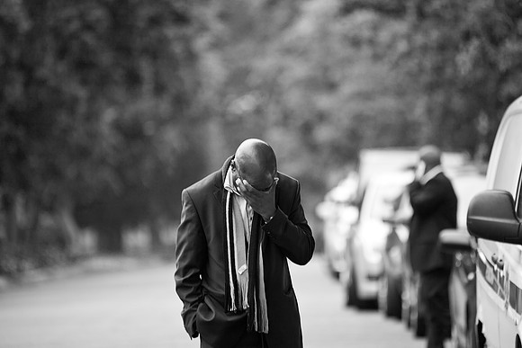 One of Mandela's security guards, paces the street outside his home, morning of his death. 05.12.13